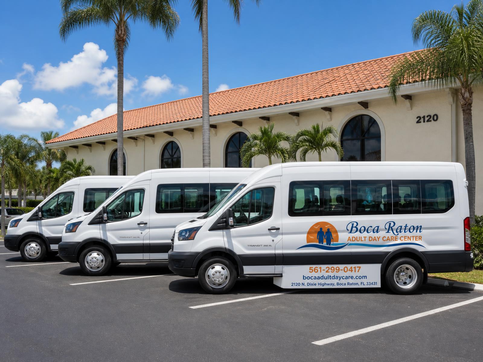 Three white 15-passenger Boca Raton Adult Day Care Center transportation vans parked in front of the center at 2120 N. Dixie Highway